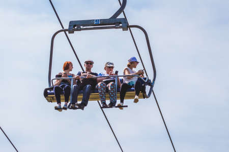 Ukraine, Carpathians, Bukovel. August 2019. People climb a mountain on a hoistのeditorial素材