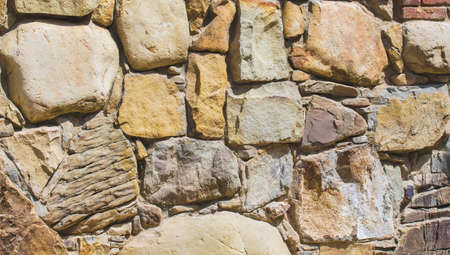 Background of masonry. Wall of different types of stoneの写真素材