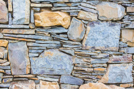 Background of masonry. Wall of different types of stoneのeditorial素材