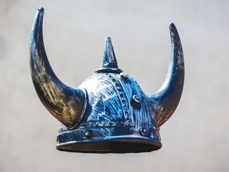 Helmet of medieval warrior on gray background, knightly helmet with horns