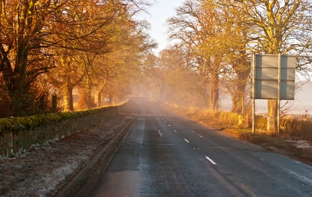 Country highway in Scotland vanishing in mystic  fogの写真素材