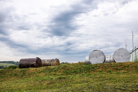rusty discarded tanks out in a fieldの写真素材