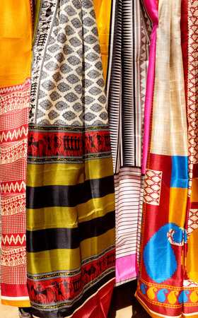 colorful fabrics and shawls at a market stall