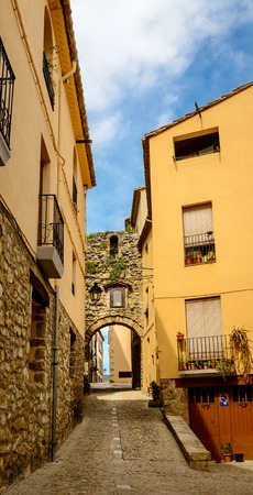 Narrow street with arch at end in medeival town of Besaluの写真素材