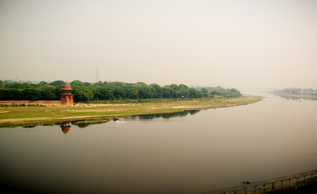 Yamuna river and a man in boat. Misty View from Taj Mahalの写真素材