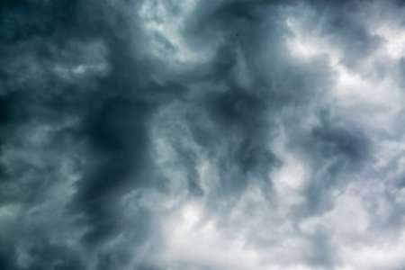Black stormy dramatic clouds in gloomy sky