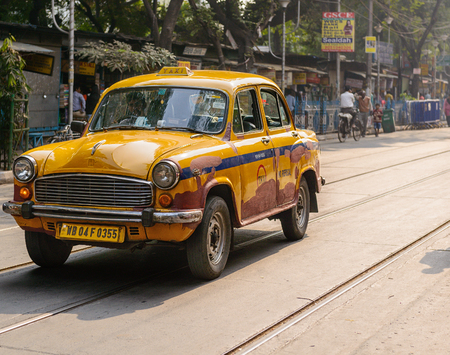 Yellow Ambassador Taxi in a street in Kolkataのeditorial素材