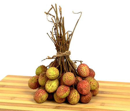 Bunch of lychee on old wooden cutting boardの写真素材
