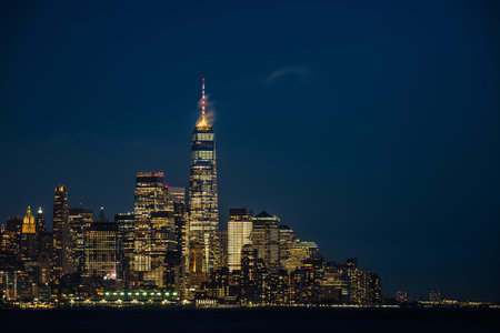Night view of Lower Manhattan skyline featuring the illuminated One World Trade Center in New York Cityの写真素材