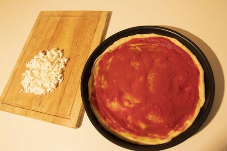 Dough for pizza with tomato and ready mozzarellaの写真素材