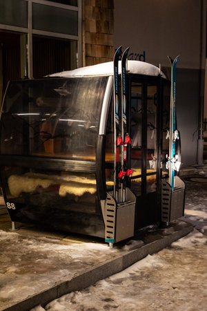 A close-up shot of a ski gondola in Obertauern, Austria, with skis inside. The gondola is partially...