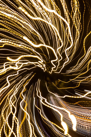 A captivating abstract photograph showcasing vibrant light trails swirling through a foggy atmosphere. Captured during a Christmas photowalk in the charming city of Salzburg, Austria, this image evokes a sense of festive energy and urban dynamism. The blurred lights create a mesmerizing pattern, perfect for conveying a feeling of movement and excitement.の写真素材