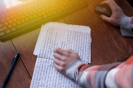 A student works with a notebook and a computer on the desktop, education, homeworkの写真素材