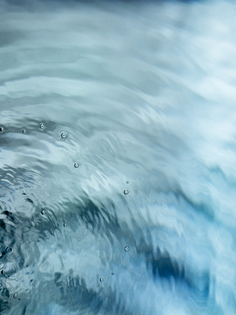 Painterly, tranquil, and meditative blue green flowing water backgroundの写真素材