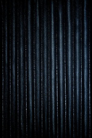 Dark blue corrugated metallic texture industrial abstract pattern background with ridgesの写真素材