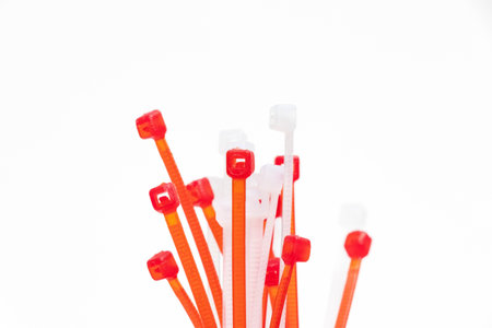 many red and white zip ties isolated on white