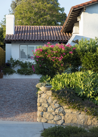 Sandstone wall, succulents and rosemary along a driveway.の写真素材