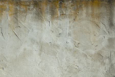 A detail shot of a plaster wall with natural weathering from the elementsの写真素材
