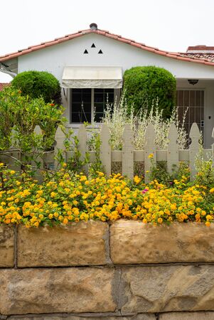 California garden planting example with flowers, wood fence, and other native plantsの写真素材