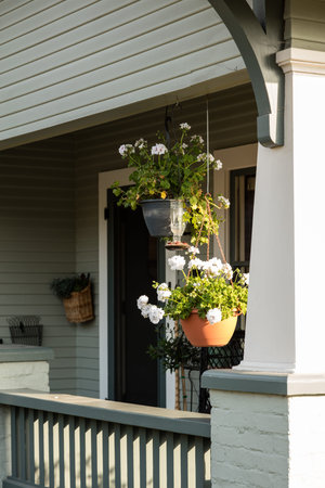 Hanging pots over the front patio of a house in Californiaの写真素材