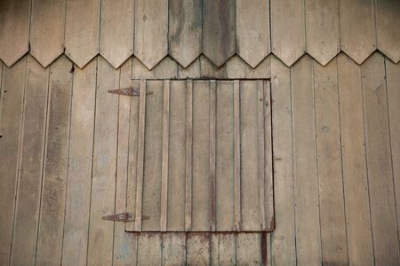 An old wood barn door and facade detail showing its age and authentic weathered lookの写真素材
