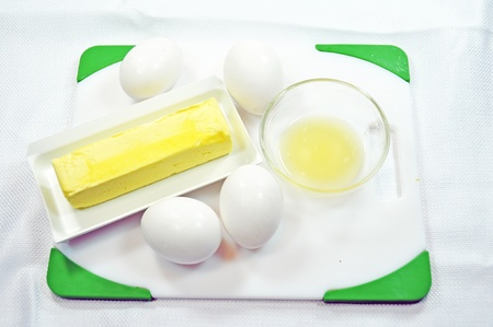 Eggs butter and lemon juice on a white backgroundの写真素材