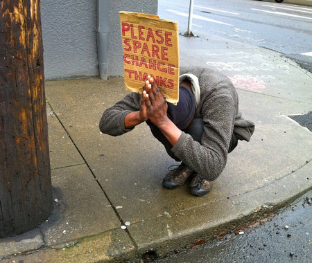 Panhandler in Portland, Oregon, takes on prayerful pose to entice motorists to donate spare change