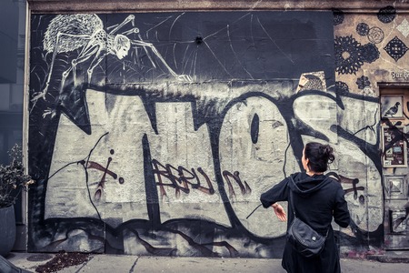 Graffity on Wall behind a Person in urban area in Austriaの写真素材