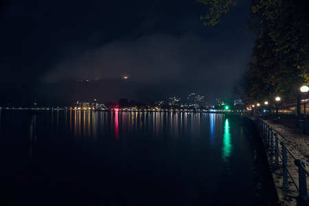 lake Bodensee at night longtime exposre with reflections in the water from the lights of the other side of the lakeの写真素材