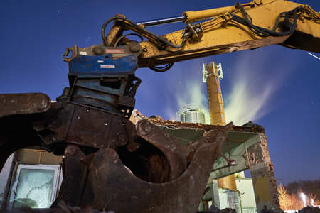 Excavator on stones at night, dark and blueの写真素材