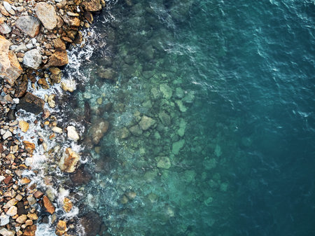 Top drone shot of blue ocean water in turkey. aerial evening mood of the coast beach. waves of...