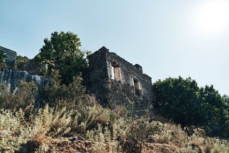 The abandoned Greek village of Kayakoy, Fethiye, Turkey. Ghost Town Kayakoy. Turkey, evening sun. Ancient abandoned buildings of rock and stone.の写真素材