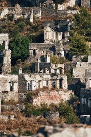 The abandoned Greek village of Kayakoy, Fethiye, Turkey. Ghost Town Kayakoy. Turkey, evening sun. Ancient abandoned buildings of rock and stone.の写真素材