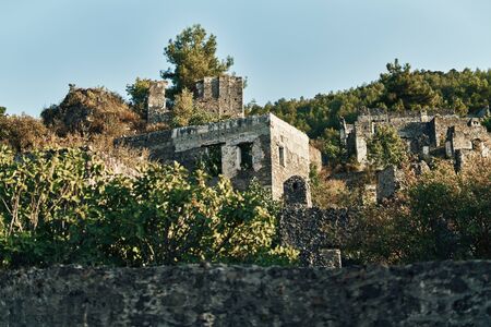 The abandoned Greek village of Kayakoy, Fethiye, Turkey. Ghost Town Kayakoy. Turkey, evening sun. Ancient abandoned buildings of rock and stone.の写真素材