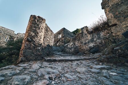 The abandoned Greek village of Kayakoy, Fethiye, Turkey. Ghost Town Kayakoy. Turkey, evening sun. Ancient abandoned buildings of rock and stone.の写真素材