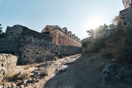 The abandoned Greek village of Kayakoy, Fethiye, Turkey. Ghost Town Kayakoy. Turkey, evening sun. Ancient abandoned buildings of rock and stoneの写真素材