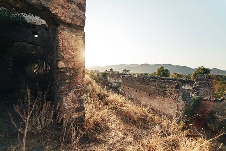 The abandoned Greek village of Kayakoy, Fethiye, Turkey. Ghost Town Kayakoy. Turkey, evening sun. Ancient abandoned buildings of rock and stone.の写真素材