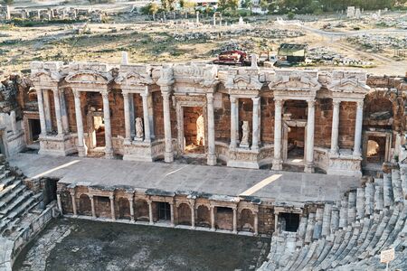 Ruins of ancient Hierapolis Amphi theatre with tourist Pamukkale, Denizili, Turkey. Evening sunの写真素材