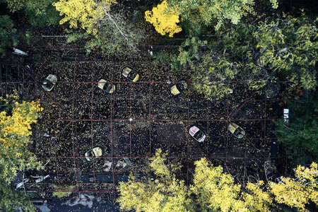 Abandoned Amusement Car Ride in Ghost City of Pripyat in Chernobyl Exclusion Zone, Scooter in Autumn Colors from drone viewの写真素材