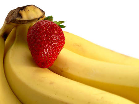Isolated bananas and a strawberryの写真素材