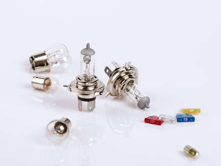 The photo shows spare bulbs and some fuses over whiteの写真素材