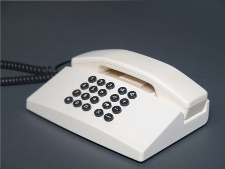 The image shows a desk telephone over gray background