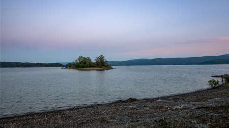 Late evening long exposure of lake with island pink skyの写真素材
