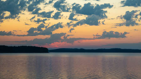 Dawn colorful skies over lakeの写真素材