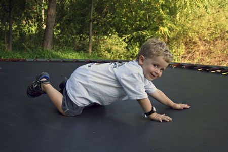 boy on trampolineの写真素材