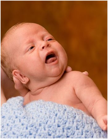 crying newborn in mothers armsの写真素材