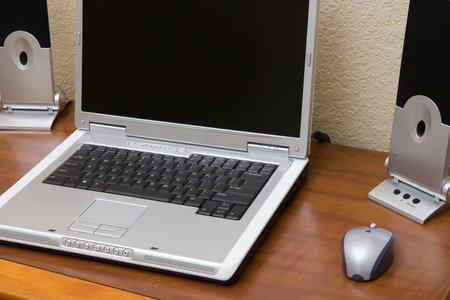 trendy new laptop and speakers with wireless mouse