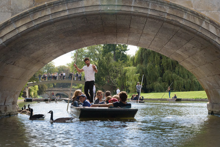 CAMBRIDGE, UK - SEPTEMBER 16, 2018: Punt boat tour about to pass through The Avenue Bridge next to Trinity College, Cambridge, Englandのeditorial素材