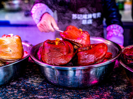 Barbecued red meat in a metal bowl at a street food marketの写真素材