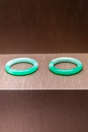 Close-up of two green rubber rings on a steel plate.